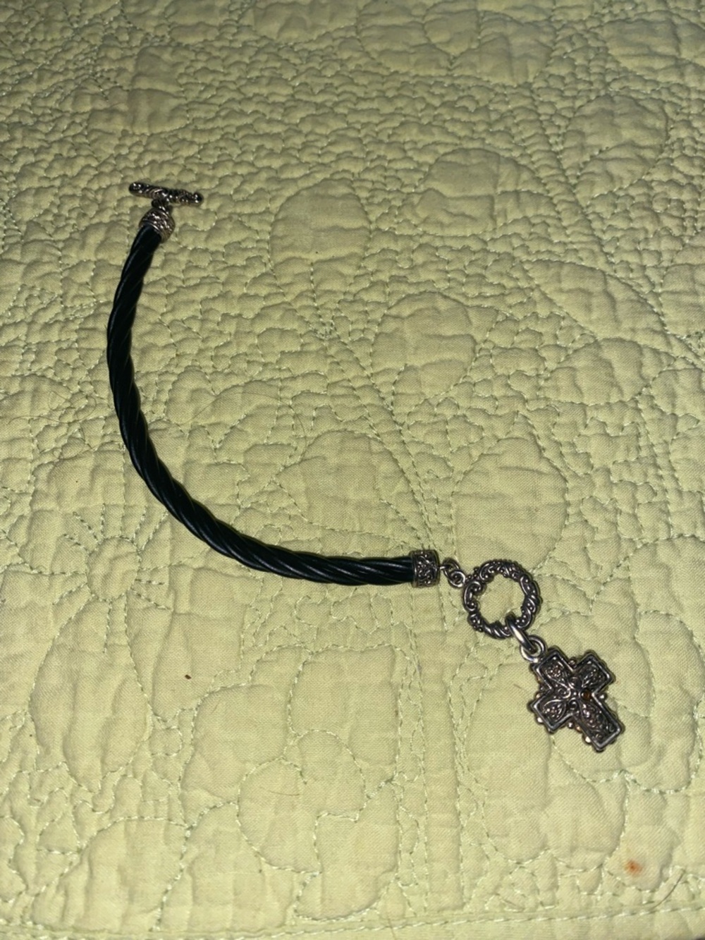 Silver-toned cross pendant paired with a cord bracelet featuring a toggle clasp - Picture 3 of 3